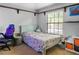 A bedroom including a soft bed, gray walls and a large window at 11783 Ashley Ct, Seminole, FL 33772
