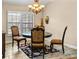 Cozy dining area with a chandelier, plantation shutters, and elegant furnishings at 11783 Ashley Ct, Seminole, FL 33772