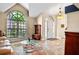 A bright foyer featuring tile floors, a decorative chandelier, and an arched window at 11783 Ashley Ct, Seminole, FL 33772