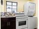 Convenient laundry area equipped with modern appliances and ample counter space at 11783 Ashley Ct, Seminole, FL 33772