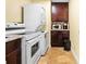 Convenient laundry area features a stacked washer and dryer, cabinets, and an oven at 11783 Ashley Ct, Seminole, FL 33772