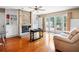 Bright living room with brick fireplace, wood floors, and french doors to backyard at 11783 Ashley Ct, Seminole, FL 33772