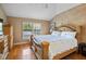 The main bedroom with hardwood floors has a vaulted ceiling and a window with wooden blinds at 11783 Ashley Ct, Seminole, FL 33772