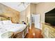 A main bedroom showcases a wooden bed frame, hardwood floors, and a doorway to another room at 11783 Ashley Ct, Seminole, FL 33772