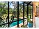 A screened-in pool offers a serene view of the lush backyard, bringing the outdoors in at 11783 Ashley Ct, Seminole, FL 33772
