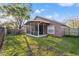 Beautifully landscaped back yard featuring fire pit, seating area, and screened in patio at 11808 Lancashire Dr, Tampa, FL 33626