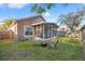 Landscaped back yard features screened in patio and fire pit area for relaxing outdoors at 11808 Lancashire Dr, Tampa, FL 33626