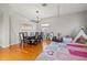 Bright and airy dining room featuring a stylish chandelier, a play area, and hardwood floors at 11808 Lancashire Dr, Tampa, FL 33626