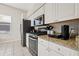 Kitchen features granite countertops, stainless steel appliances, white cabinets, and tile flooring at 11808 Lancashire Dr, Tampa, FL 33626
