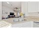 The kitchen features a granite countertop, stainless sink, and open access to the living room at 11808 Lancashire Dr, Tampa, FL 33626