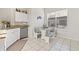Cozy eat-in kitchen with tile floors, granite countertops, stainless appliances, and a charming dining nook at 11808 Lancashire Dr, Tampa, FL 33626