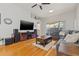 Cozy living room with a plush sectional sofa, hardwood floors, and a media center for entertainment at 11808 Lancashire Dr, Tampa, FL 33626