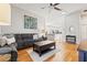 Bright living area featuring hardwood floors, modern decor, and seamless flow to the dining area and kitchen at 11808 Lancashire Dr, Tampa, FL 33626