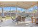 Relaxing screened patio complete with comfortable seating, dining area, string lights and outdoor grill at 11808 Lancashire Dr, Tampa, FL 33626