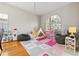 Spacious playroom area bathed in natural light with toys, play equipment, and hardwood floors at 11808 Lancashire Dr, Tampa, FL 33626