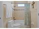 Bathroom featuring a tub with shower, tiled walls, and decorative shower curtain at 11906 Middlebury Dr, Tampa, FL 33626