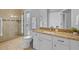 Bathroom featuring granite counters, tile floors, glass shower, and updated fixtures at 11906 Middlebury Dr, Tampa, FL 33626