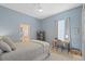 Cozy bedroom with a desk, bookshelf, and view into the attached bathroom at 11906 Middlebury Dr, Tampa, FL 33626