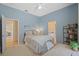 Relaxing bedroom in soft hues with desk, bookshelf, and view into the bathroom at 11906 Middlebury Dr, Tampa, FL 33626