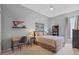 Well-lit bedroom features a desk, ceiling fan, and Alabama decor at 11906 Middlebury Dr, Tampa, FL 33626
