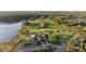 Serene golf course, featuring an elegant clubhouse next to a scenic lake and lush landscaping at 11906 Middlebury Dr, Tampa, FL 33626