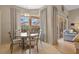 Dining area featuring a round wood table, neutral paint, tile flooring, and access to the living room at 11906 Middlebury Dr, Tampa, FL 33626