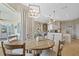 Casual dining area with tile flooring, a chandelier, and views of the outdoor space at 11906 Middlebury Dr, Tampa, FL 33626