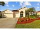 Charming single-story home featuring a well-manicured lawn, complemented by a three-car garage and a welcoming entrance at 11906 Middlebury Dr, Tampa, FL 33626