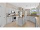 Bright kitchen featuring white cabinetry, stainless steel appliances, granite countertops, and an island at 11906 Middlebury Dr, Tampa, FL 33626