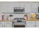 Modern kitchen featuring a stainless steel oven, gas range, granite countertops, and white subway tile backsplash at 11906 Middlebury Dr, Tampa, FL 33626