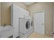 Well-equipped laundry room featuring a modern washer and dryer, built-in cabinets, and a sink at 11906 Middlebury Dr, Tampa, FL 33626