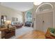 Bright living room showcasing a soaring window, neutral decor, and an open layout with hardwood and carpet flooring at 11906 Middlebury Dr, Tampa, FL 33626