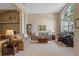 Inviting living room filled with neutral tones, comfortable seating, a piano, and an elegant grandfather clock at 11906 Middlebury Dr, Tampa, FL 33626