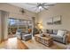 Bright living room featuring a ceiling fan, neutral paint, and a sliding glass door offering access to an outdoor living space at 11906 Middlebury Dr, Tampa, FL 33626