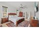 This is a spacious main bedroom with beautiful wood furnishings, soft rug, and large ceiling fan at 11906 Middlebury Dr, Tampa, FL 33626