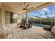 Inviting screened patio with comfortable seating, ceiling fan, and poolside view at 11906 Middlebury Dr, Tampa, FL 33626