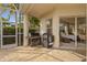 Covered patio with outdoor kitchen, grill, and view into the home's interior at 11906 Middlebury Dr, Tampa, FL 33626