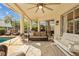 Relaxing screened patio with comfortable seating, ceiling fan, and poolside view at 11906 Middlebury Dr, Tampa, FL 33626