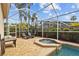 Backyard pool and jacuzzi area with screened enclosure and lounge seating at 11906 Middlebury Dr, Tampa, FL 33626