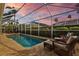 Inviting screened-in pool area featuring a sparkling pool, spa and comfortable lounge seating for relaxing outdoors at 11906 Middlebury Dr, Tampa, FL 33626