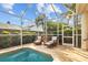 Beautifully screened pool area with seating, lush landscaping and privacy at 11906 Middlebury Dr, Tampa, FL 33626
