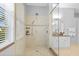 This is a stunning bathroom shower with glass enclosure, mosaic tiling, and neutral stone at 11906 Middlebury Dr, Tampa, FL 33626