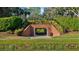 Charming brick pedestrian tunnel providing access beneath a walkway, surrounded by community landscaping at 11906 Middlebury Dr, Tampa, FL 33626