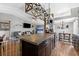 Open-concept kitchen flows into the living room, featuring a kitchen island and modern appliances at 1208 Sawgrass Ct, Oldsmar, FL 34677