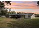 Spacious backyard with screened-in pool and room to roam, plus beautiful sunset views at 1226 Debuel Rd, Lutz, FL 33549