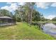 Backyard with pool area and pond, creating a serene and natural setting at 1226 Debuel Rd, Lutz, FL 33549
