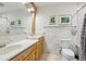 Bright bathroom features a dual sink vanity, framed mirrors, and a toilet at 1226 Debuel Rd, Lutz, FL 33549