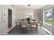 Dining room showcasing modern lighting, neutral tones, and a stylish area rug at 1226 Debuel Rd, Lutz, FL 33549