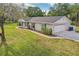Well-maintained home with a two-car garage, manicured lawn, and lovely landscaping at 1226 Debuel Rd, Lutz, FL 33549