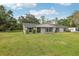 Charming brick home with a well-manicured lawn and mature landscaping at 1226 Debuel Rd, Lutz, FL 33549